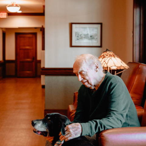 Resident Petting a Visiting Dog at The MacLean House