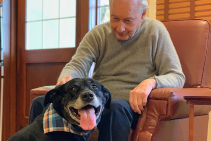 Resident Petting a Visiting Dog at The MacLean House