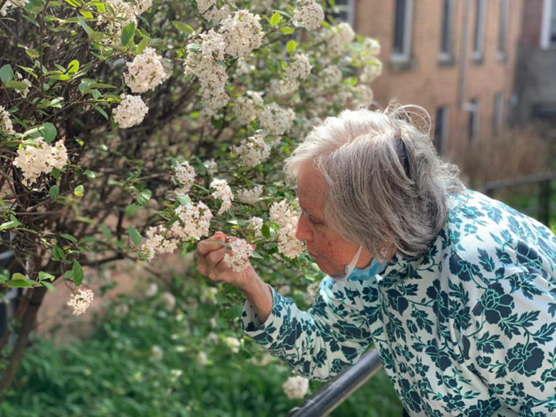 Resident Smelling the Flowers